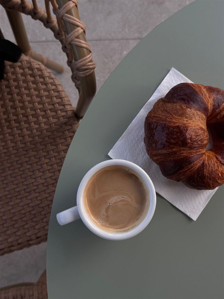 Croissant and coffee on a small round table