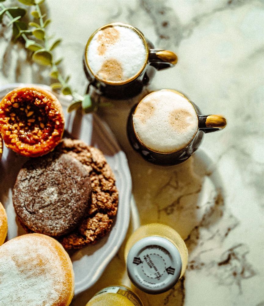 Flat lay of pastries and coffee on marble
