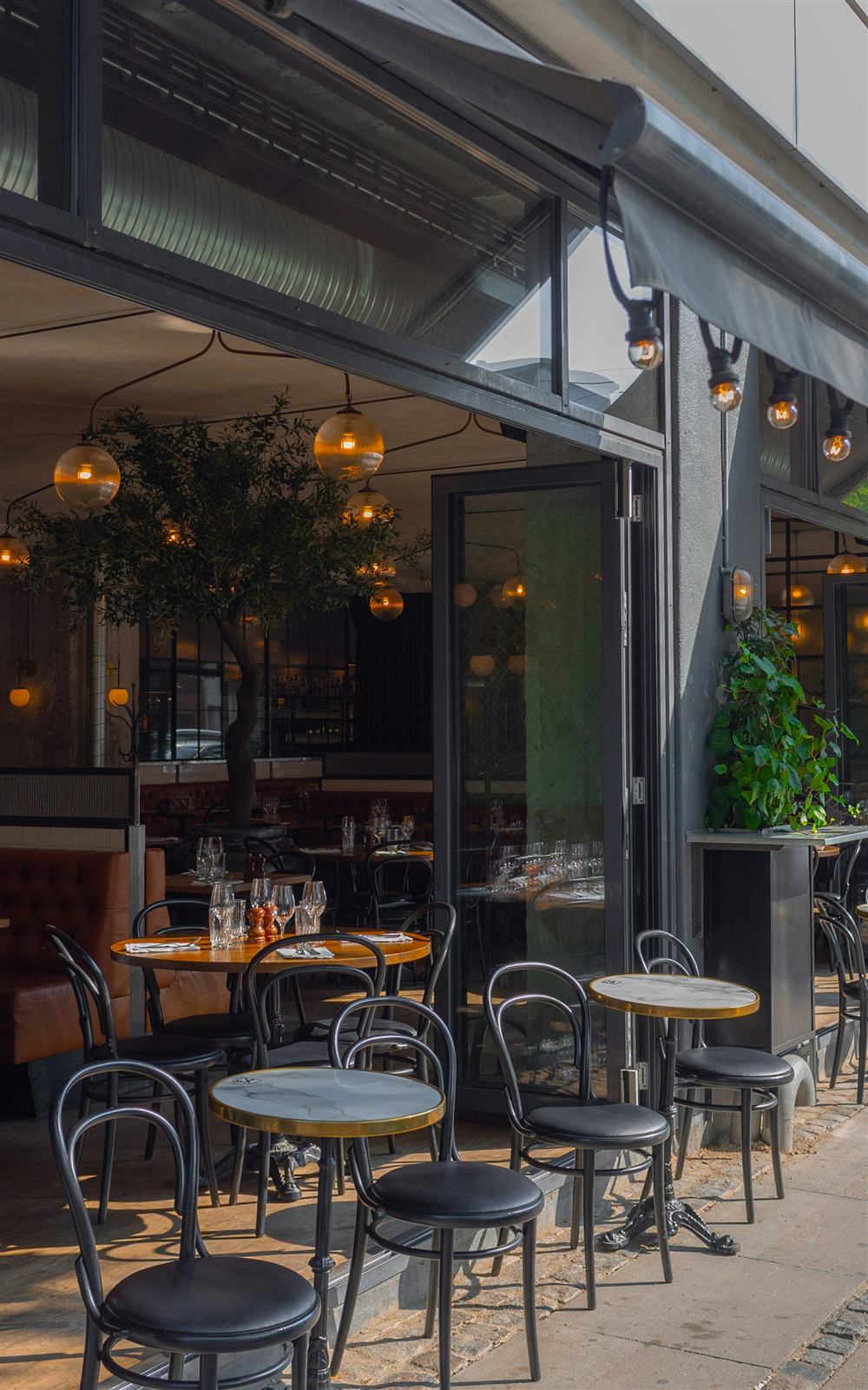 The bakery's sidewalk seating under string lights
